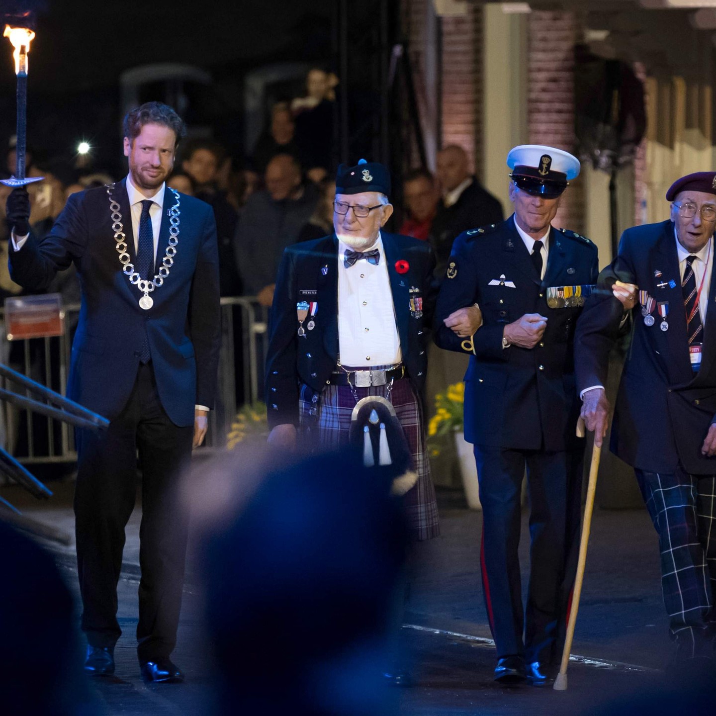 On 5 May 2024, 13 British veterans and one Canadian veteran led the Liberation Day Parade through Wageningen, applauded by thousands who lined the route.
The British veterans had travelled to the Netherlands with the Taxi Charity for Military Veterans, which has been making the annual trip for Dutch Liberation since 2012. They were joined by a Canadian veteran for the weekend in Wageningen, the Dutch city of liberation.
In the Netherlands, 4 May is the national day of remembrance. British Market Garden veteran, Geoff Roberts, had the honour of lighting the flame of liberation with Canadian veteran, George Brewster, at midnight in the Wageningen town square, watched by millions on Dutch TV.
The following day, thousands of people arrived in Wageningen to watch the annual Liberation Day Parade, which was led by three golf carts and two London cabs carrying the Taxi Charity veterans.
The veterans were showered with flowers, gifts and a thunderous round of applause during the 5km route; and it was heartening to see the tears shared by the veterans and the families of those they had liberated 79 years before.
During lunch on 4 May, Hans Kranenburg, President of the Police Sport Association, who addressed the veterans, said: "We are extremely honoured and privileged with your presence. Without your sacrifices, and those of the many soldiers and freedom fighters, we would not have been able to stand here to speak freely and to walk in freedom. Words cannot express what you have done for us. We will never fully understand the depth of your scars. Your dedication and commitment to liberate our country will always be in our hearts and minds. We owe you so much.”
Taxi Charity advisor, Frans Ammerlaan MBE, from the Market Garden Foundation, said: “We look forward to welcoming British veterans to the Netherlands each year and it is always such a pleasure to host these brave men and women.”
Dick Goodwin, honorary secretary of the Taxi Charity for Military Veterans, said: “The party of veterans had such a wonderful time thanks to the carers, volunteers, London cab drivers and our old and new Dutch friends.
📸 Photos courtesy of Arjan Vrieze.