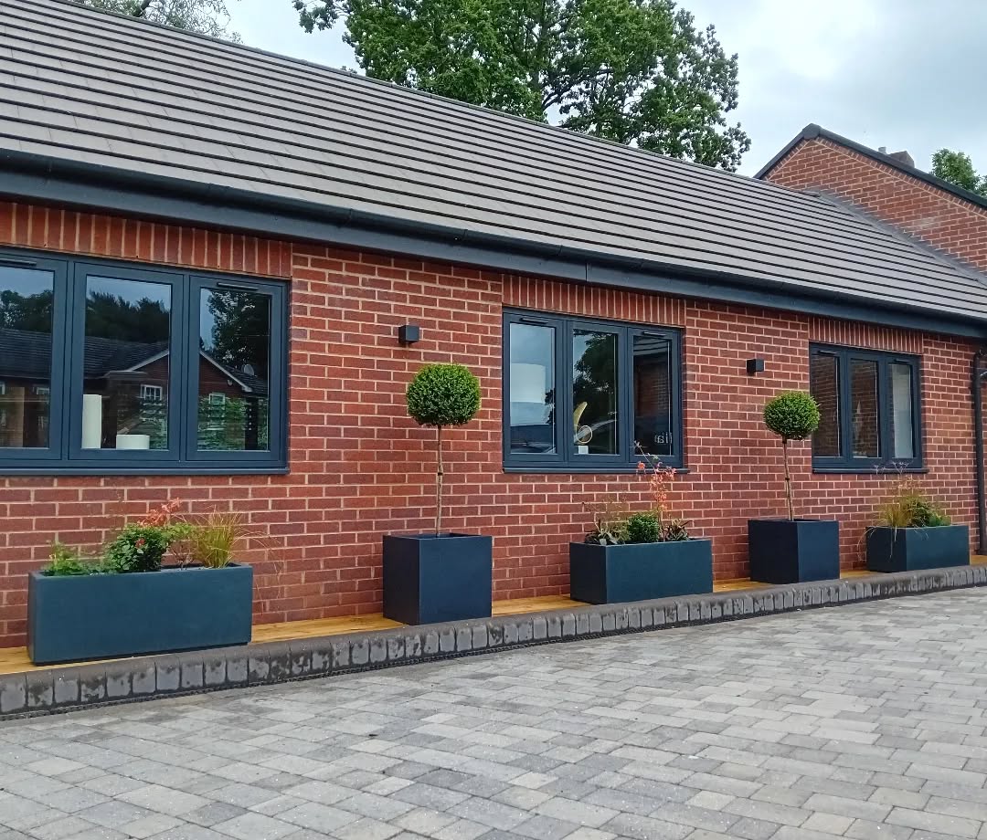 New planters really bring the front of this house to life, softening the architecture and adding interest and colour as the plants grow and come into flower.