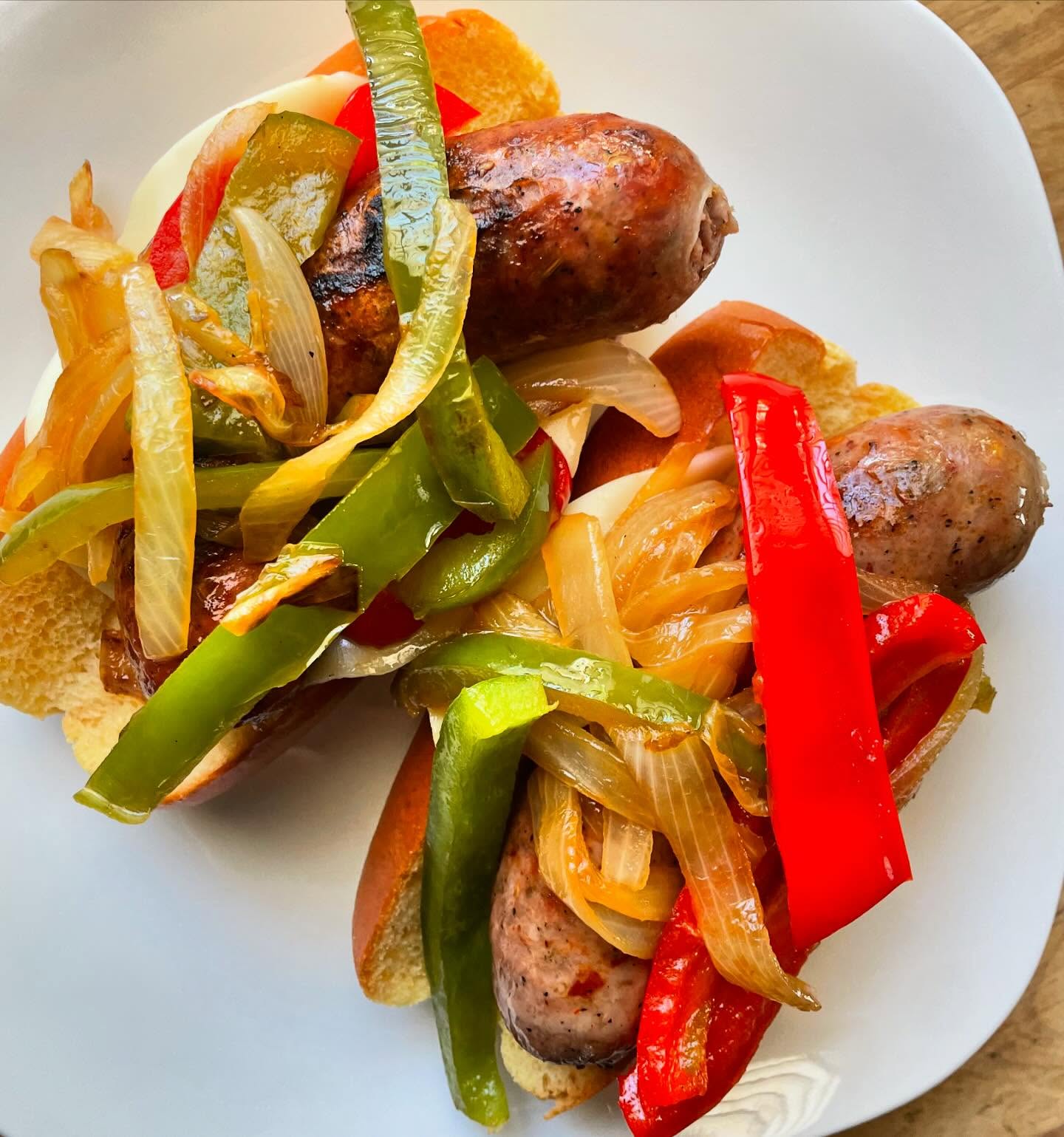 Sausage and peppers season has officially begun! Here is one of the easiest ways to get it done. Stop by @slcfarmersmarket or @wheelerhistoricfarm this weekend and pick up some Italian links or coils for this easy east coast Italian classic.
**🍽️ Sausage & Peppers for 4🍽️**
**Ingredients:**
- 4 of our medium-hot Italian fennel sausage links (grilled)
- 2 green bell peppers, sliced
- 2 red bell peppers, sliced
- 2 medium onions, sliced
- 3 tbsp olive oil
- Salt & cracked pepper to taste
- 5 soft Italian or French rolls
**Instructions:**
1. **Prep Veggies**: Slice green & red peppers, and onions.
2. **Sauté**: Heat 3 tbsp olive oil in a saute pan over medium heat. Add onions, cook until soft.
3. **Add Peppers**: Add green & red peppers. Cook until tender, about 10 minutes.
4. **Season**: Sprinkle with salt & cracked pepper.
5. **Combine**: add the grilled sausages to the pan. Stir to combine, cook for another 5 minutes.
6. **Serve**: Load the sausage and peppers into soft Italian or French rolls.
#sausageandpeppers 🌶️🌭🥖