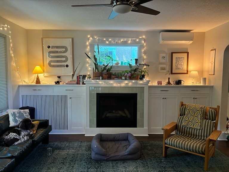 Radiator cover plus a ton of storage on either side of the fireplace.