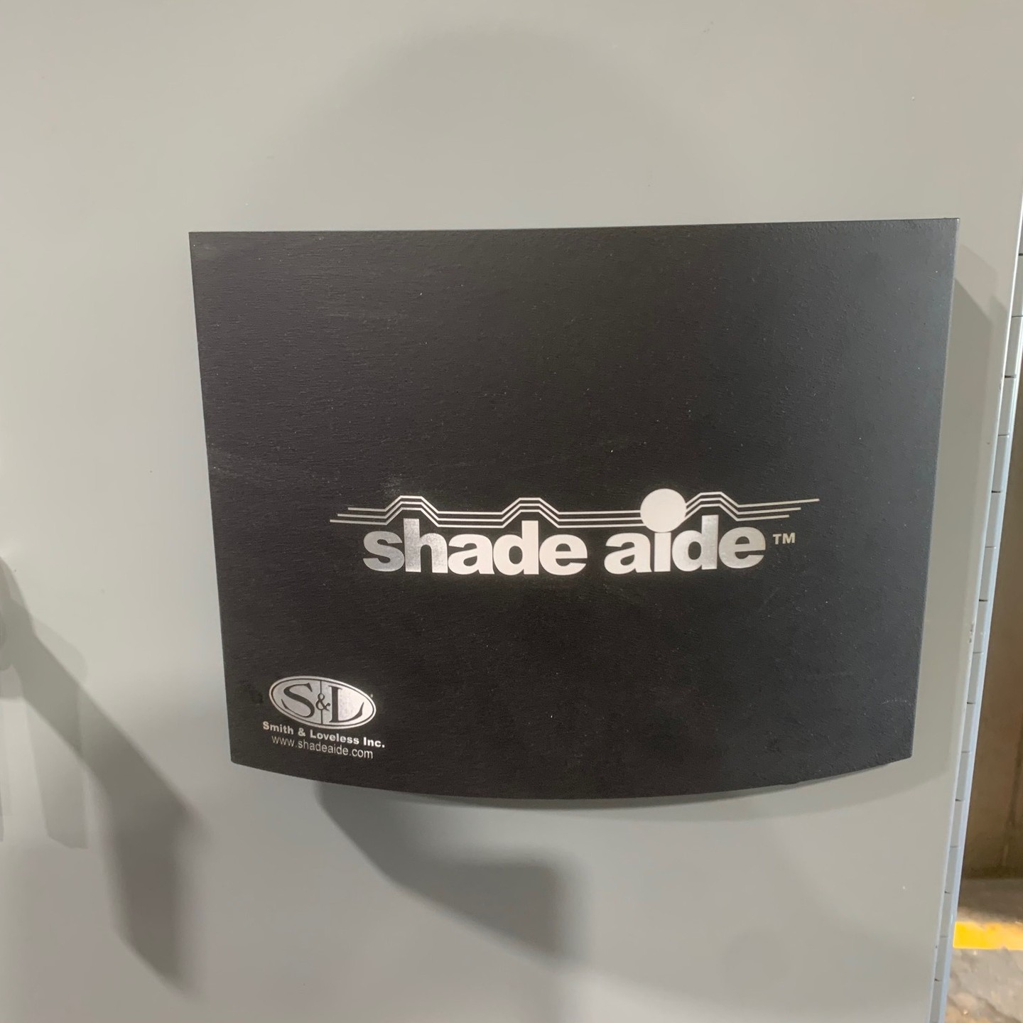 The images show a SHADE AIDE® made by Smith and Loveless that we installed onto a HMI. This system acts to protect HMI’s from the sun’s rays which damage HMI’s overtime. When expanded from its compact form, it provides shade and acts as a cover that allows users to interact with the HMI in any and all weather conditions.