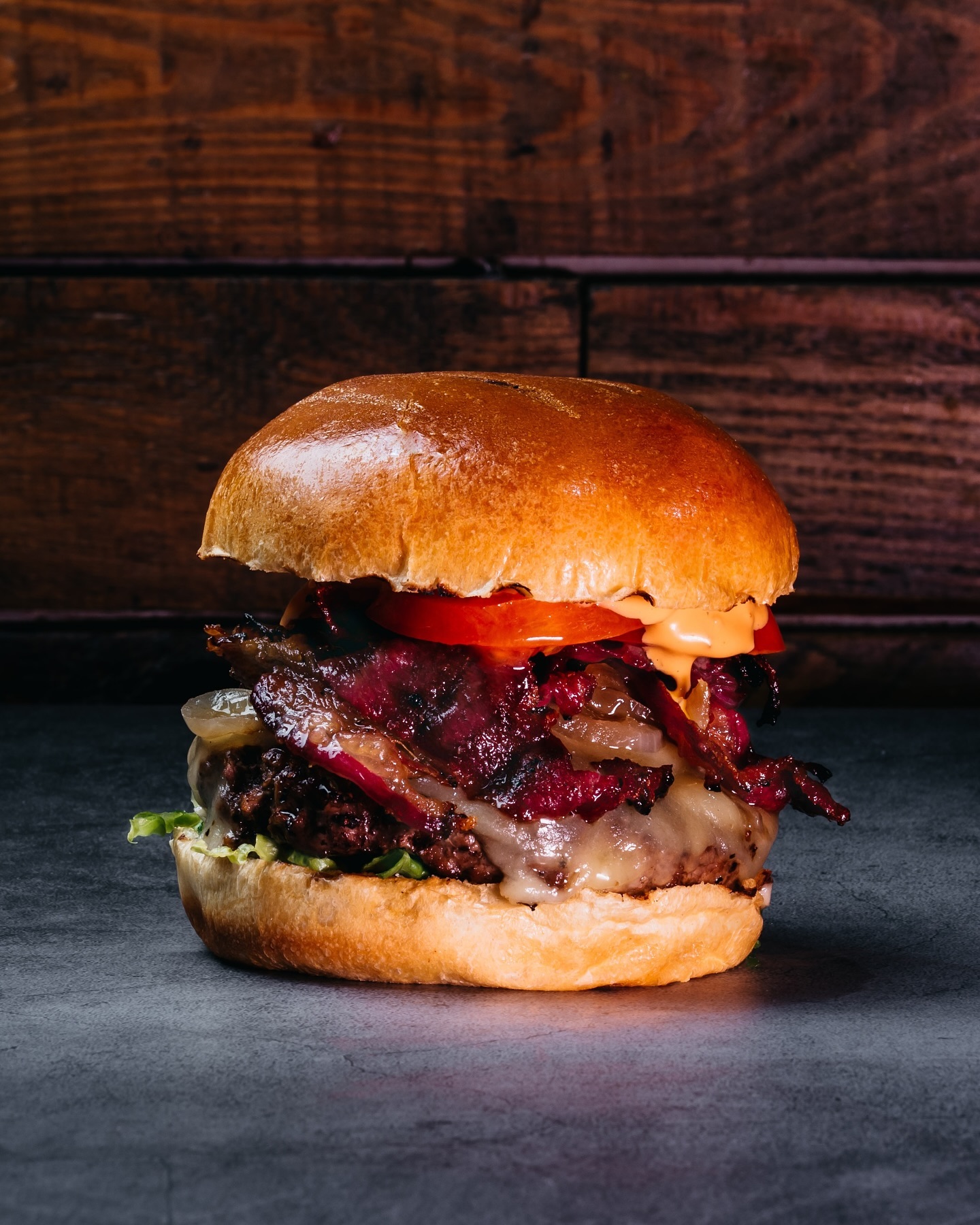 Stacked to perfection with a 6oz beef patty, cheese, lettuce, tomato, caramelised onions, beef bacon, and a touch of ketchup & mayo ๐