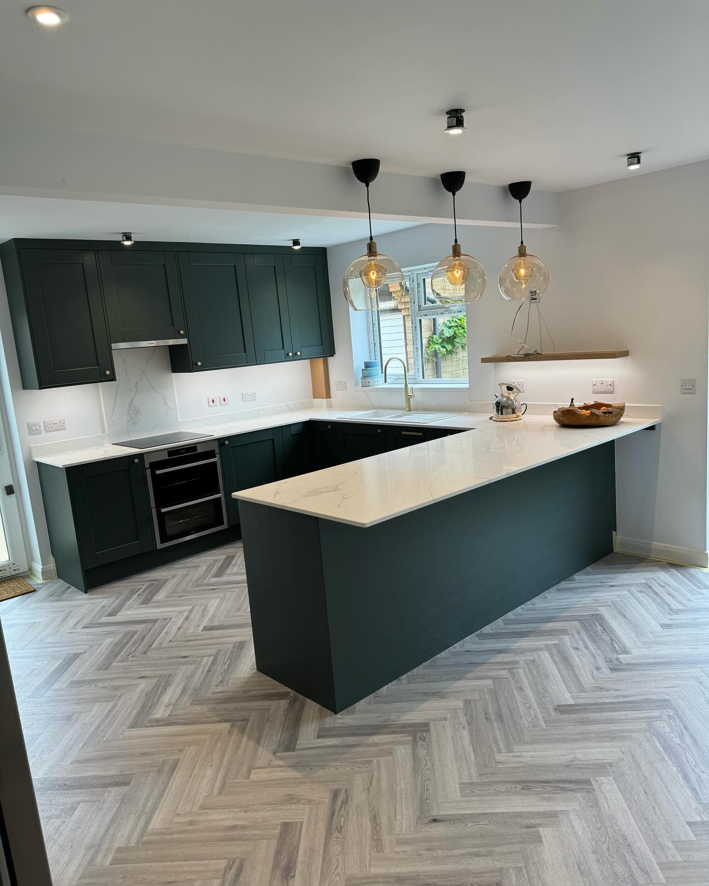 Brampton kitchen completed. ✔️
Big transformation on this project. Swipe for before and during photos ⏭️⏩️➡️
@stori_collection Kennington heritage green door. 🚪
@franke_uk sink and tap. 🚰
All the electrical works provided by @capelesshero1 ⚡️ 💡
Plastering from @smoothsi1
Wall removed and structural steel installed thanks to @mattpeacey 🧱
Flooring from @flooredbyjack
Full redecoration from @r.f.m_paintinganddecorating 🎨
Great effort from the whole team on this kitchen. If you thinking of doing something similar please get in touch.
Email ashleyking@ashwood1.co.uk ✉️
#kitchen #kitchendesign #kitchenrenovation #kitchenremodel #kitcheninspiration #kitchensofinstagram #kitchensofinsta #freequotes #kitchenfitter #ashwoodkitchens #buildingwork #buildingworks #heringbonefloor #stori #quartzworksurfaces #quartz #quartzworktops #stoneworktops