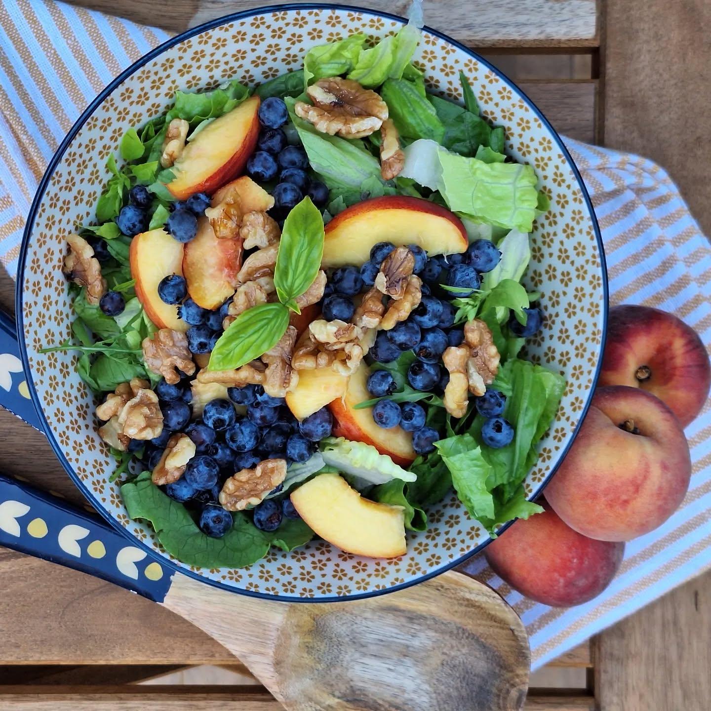 August is the best time to enjoy all the seasonal fruit and vegetables at your local farmers' market. This salad marries 2 of my favorites: ripe peaches and wild blueberries. I've thrown in some candied walnuts for crunch and basil from the garden. Served with a balsamic vinaigrette, it's the perfect light summer lunch or salad accompaniment.