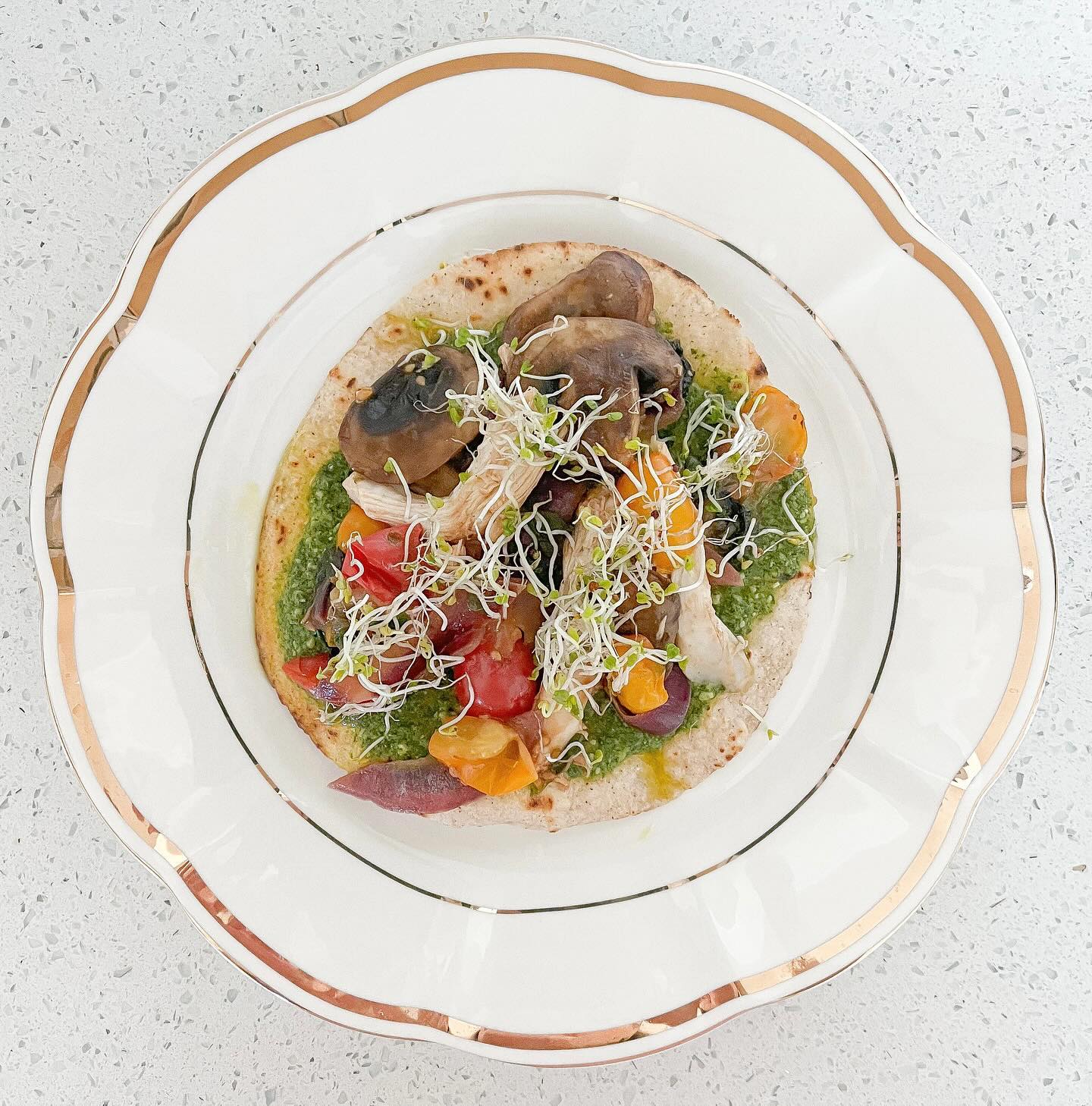 This is one of my favorite go-to lunches! It’s soooo yummy, fast, and easy!!!
PESTO CHICKEN VEGGIE “PIZZA” (GF, DF)
- 1 tortilla (I use @sietefoods )
- Basil Pesto (I use @gothamgreens vegan pesto)
- Small handful of Baby Bella mushrooms
- 1/2 cup of spring mix
- Cooked chicken, shredded (I use a rotisserie chicken from @wholefoods )
- Small handful of cherry tomatoes, halved
- 1/4 of a red onion, sliced
-Salt
- Microgreens (optional)
1. Cook the tortilla on both sides on a skillet or frying pan until crunchy. I add a little avocado oil to the pan! Set tortilla aside on a plate.
2. Drizzle a little avocado oil on the frying pan or skillet. Add mushrooms, spring mix, cherry tomatoes, red onion, and stir on medium heat. Sprinkle a little salt, and cook veggies stirring on and off until greens are wilted & veggies are soft! When they’re soft add chicken and stir.
3. Spread the basil pesto on the tortilla, spoon the chicken veggie mix on top of the tortilla, and sprinkle some microgreens on top. Cut with a pizza cutter and enjoy!