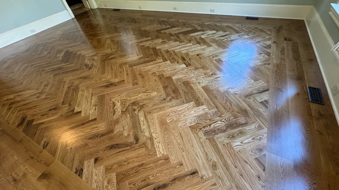 Installed over 450 SF of character-grade white oak in this stunning Ball Ground primary bedroom! Finished with golden oak stain and our upgraded oil-based poly, plus an 8-inch wide plank border for a high-end look. This home now has over 2,000 SF of Live Sawn Oak, and the result is amazing! #BallGroundGA #HardwoodInstallation #TheHardwoodGuys #WhiteOak #GoldenOakStain