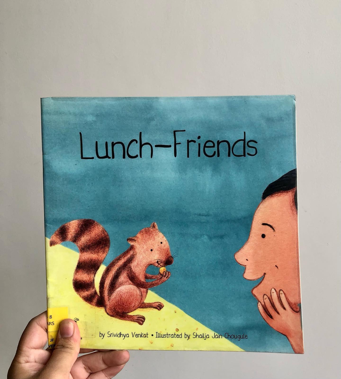 Lunch Friends
by Srividhya Venkat
Illustrated by Shailja Jain Chougule
Some books have a way of rekindling forgotten traditions, reminding us of simple joys and practices we’ve lost over time—perhaps due to busy schedules or the hustle of modern life.
Lunch Friends is one such book that takes me back to fond memories of my grandmother’s house, where summers were spent in the backyard, surrounded by birds, insects, and small animals. These creatures were cherished members of the household, not just mere animals, and were cared for like family.
In this charming story, Mihir is visiting his grandmother and notices that she leaves food out every day for the birds and squirrels that gather by the kitchen window. They live in a nearby mango tree and come to visit her daily. However, when the tree is unexpectedly cut down and the animals stop coming, Mihir comes up with a plan to bring them back.
Lunch Friends beautifully explores themes of intergenerational relationships, the love for nature, and the simple joy of sharing food. The bond between Mihir and his grandmother is heartwarming, and the story emphasizes how food can bring people—and creatures—together.
This is a delightful book for children aged 3 and up, perfect for sparking conversations about kindness, family, and the natural world.