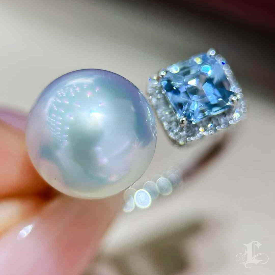 This exquisite open-ring design perfectly balances the radiant beauty of an Aurora South Sea pearl with the captivating brilliance of a rare Santa Maria aquamarine. The luminous pearl, renowned for its natural sheen and elegant roundness, is complemented by a vivid blue aquamarine gemstone delicately framed with pavé diamonds for added sparkle. The contemporary open setting highlights both stones, creating a striking yet harmonious design. Perfect for those who appreciate timeless elegance with a modern twist, this ring is a testament to sophisticated craftsmanship and exceptional materials—an ideal statement piece for any occasion.
#southseapearljewelry #southseapearlring #aquamarinering #aquamarinejewellery