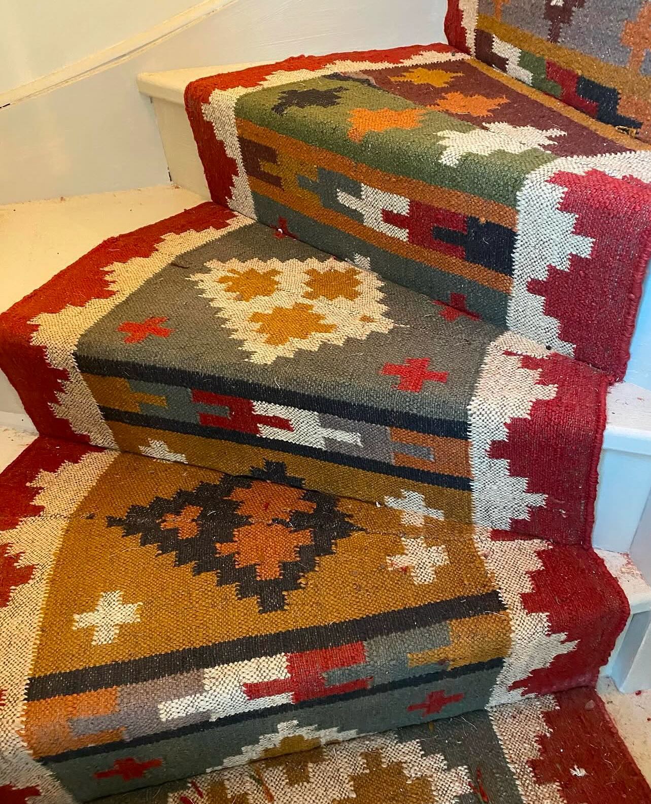 Showing just how versatile stair runners can be, this Indian Rug was cut to size to fit the stairs in this Norfolk home.
