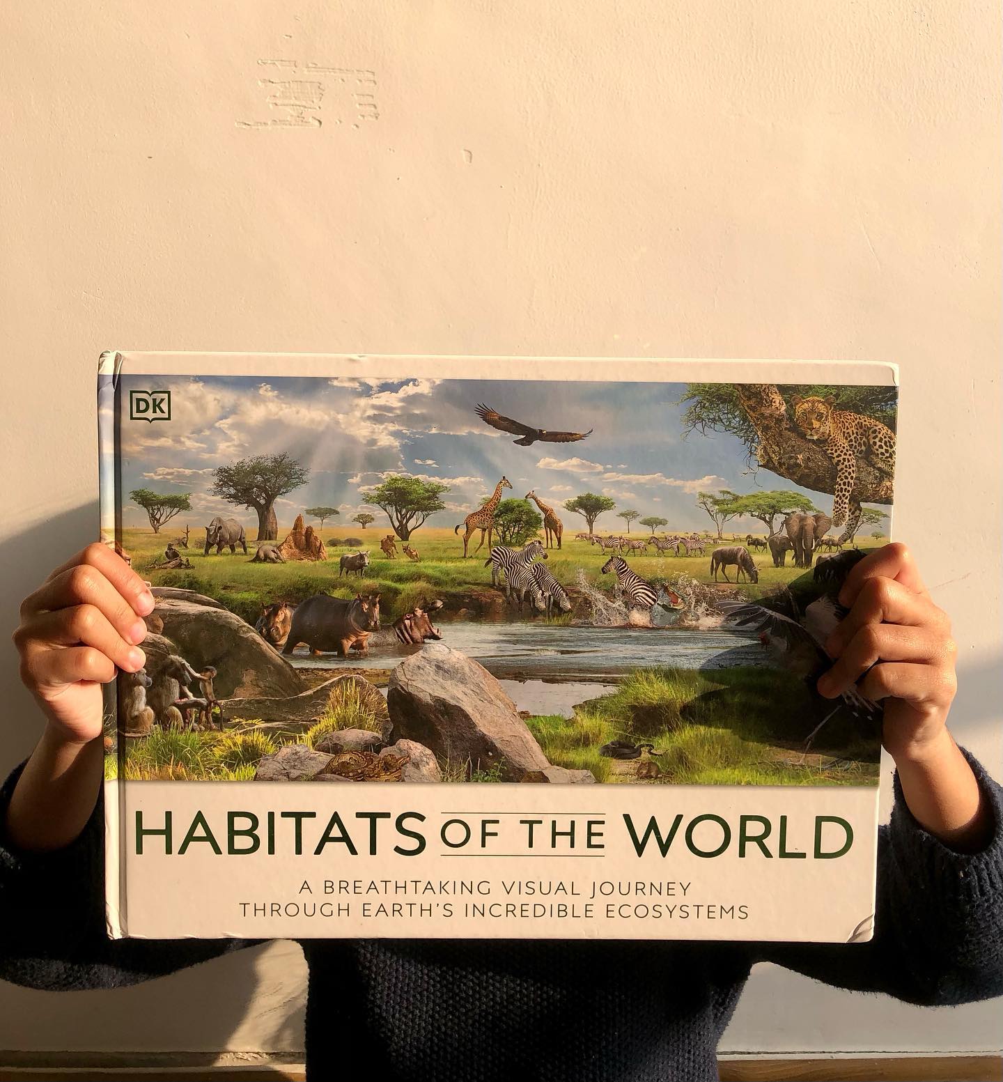 Habitats of the World
by DK
This book is an absolute treasure for nature, wildlife, and science enthusiasts of all ages! With breathtaking double-page spreads showcasing major habitats across the globe, it captivated us for months.
What We Loved:
🍀Stunning Illustrations: The CGI visuals are jaw-dropping and bring each habitat to life.
🍀 Animal Details: Informative tidbits about the animals featured in the main images are neatly presented along the page margins.
🍀 Age-Appropriate Content: The information is concise, engaging, and perfectly tailored for its intended audience.
🍀 Additional Insights: The end pages provide valuable background information that adds depth and context to the book.
What Could Be Improved:
🍀 Choice of Habitat Locations: While the book highlights a desert habitat from North America, showcasing iconic deserts like the Sahara or a cold desert would have been more impactful.
🍀 Location Emphasis: Each habitat is tied to a specific location, which might give the impression that the featured flora and fauna are exclusive to that region, potentially limiting a broader understanding of biodiversity.
All in all, Habitats of the World is a stunning visual and educational resource. If your child—or you—are curious about nature and ecosystems, this is a must-have addition to your bookshelf!