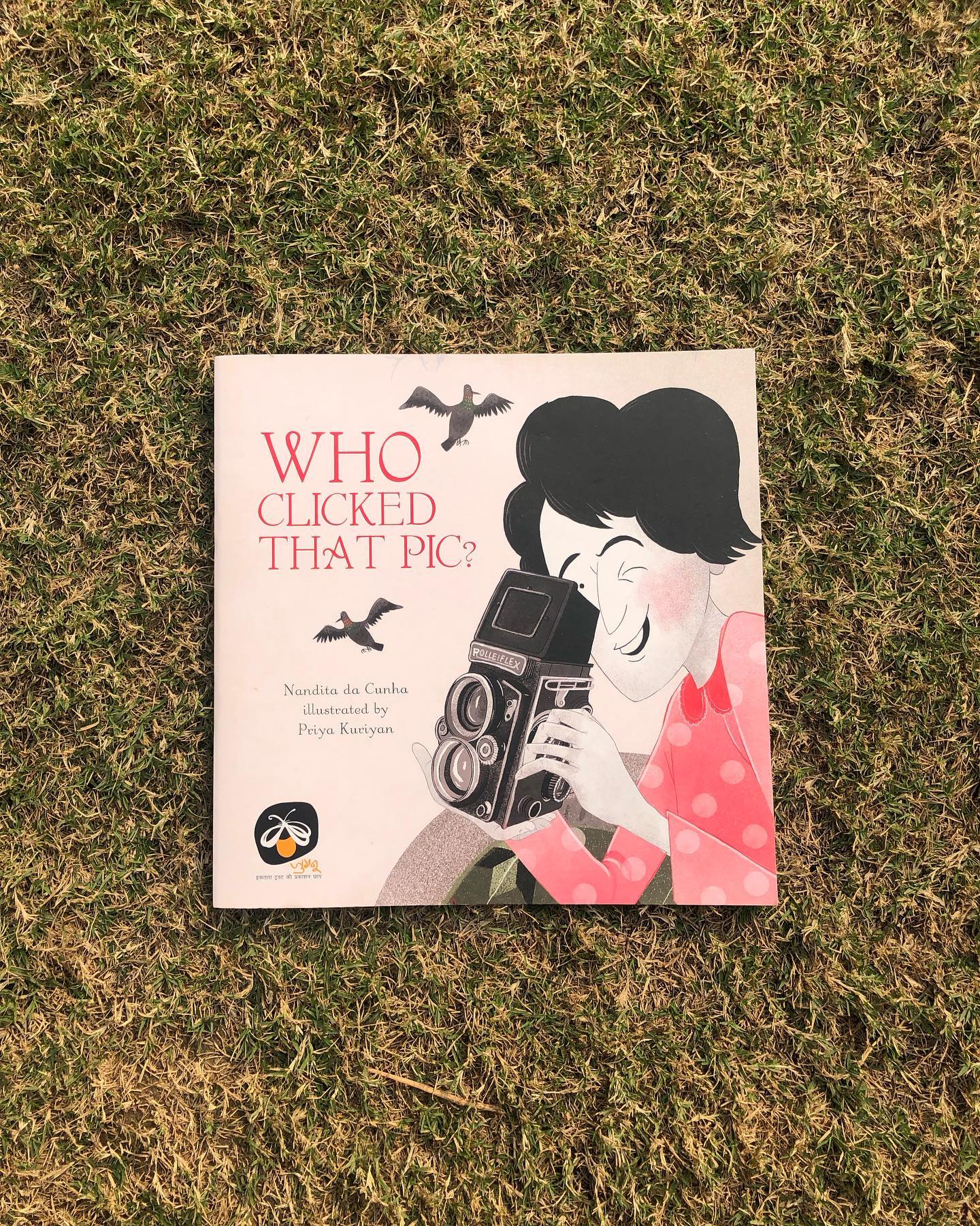 Who Clicked That Pic?
By Nandita da Cunha
Illustrated by Priya Kuriyan
Inspired by the life and work of Homai Vyrawalla, India’s first female photojournalist, Who Clicked That Pic? is a fictionalized glimpse into her journey.
The story follows Pari, a spirited young photographer, as she sets out to capture the perfect shot of the vibrant Ganpati festival. With just 10 frames left on her Rolliflex camera and barely enough resources to buy a new film roll, Pari is determined to sell her best photo to Mr. Nakhrawalla, who pays ₹1 for every selected photograph—a sum that could help her sustain her passion.
Accompanied by her friend Parvez, Pari cycles through the bustling festival streets. Amid the chaos of the celebrations, many of her shots fall short of perfection. With only a few clicks remaining and storm clouds gathering, Pari races against time, battling the elements and the odds to capture a frame that truly embodies the spirit of the festival.
This beautifully illustrated book brings the bygone era to life with vivid detail. The vibrant depictions of the Ganpati festival, the costumes, the architecture, and the bustling energy of the streets transport readers straight into the heart of the scene.
Beyond its nostalgic charm, the story offers a stark reminder of the gender barriers of the time. Pari’s talents go unacknowledged as she’s forced to sell her photos under Parvez’s name—because, in a male-dominated field, a woman’s work was unheard of. While times have changed, we all know that every progress is still a work in progress.
This book celebrates resilience, grit, and the spirit of defying the odds. Pari’s resourcefulness—whether tearing off her other sleeve to match the ripped one or climbing a building to get the perfect shot—is inspiring. As a mother, I would want my daughter to pick up on the one powerful lesson: no matter how difficult the circumstances or how steep the climb, pursue what you love with determination and courage.