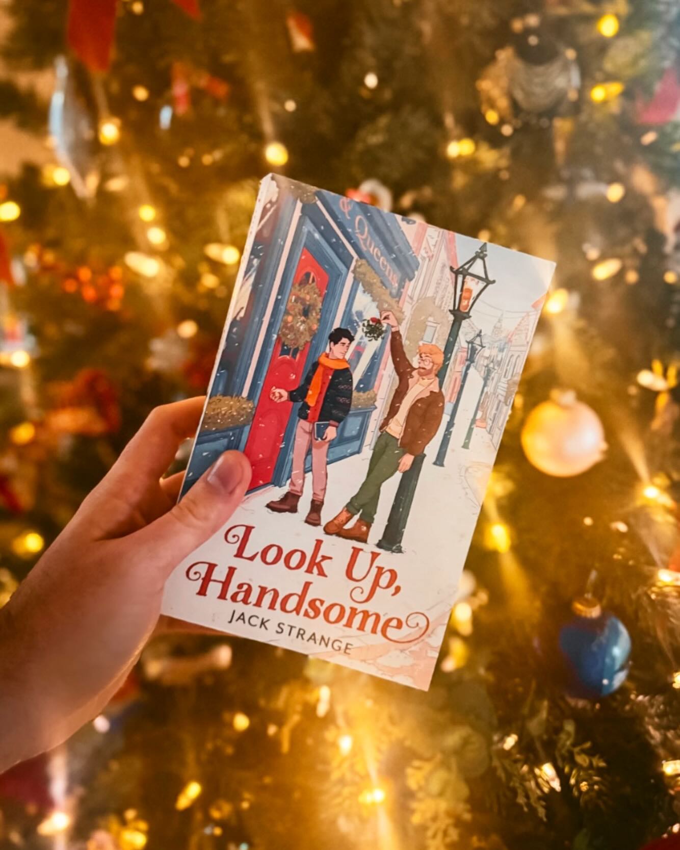 ❄️ LOOK UP, HANDSOME BY JACK STRANGE ❄️
This has been on my TBR for a while and once it released, knew I had to wait for the holidays to dive in. I’m so happy I did! This book gave me the perfect cozy romance I needed during the holidays. I mean, what’s not to love with a sunshine bookshop owner who meets a grumpy author? This one felt like a Hallmark movie, but in ALL the best ways 🥰
Description:
Quinn wants to save his bookshop, the last thing he needs is to fall in love…
Hay-on-Wye’s only queer bookshop is always a hive of activity. So when it’s threatened with closure, its owner Quinn Oxford is determined to do whatever it takes to save his beloved shop.
That is until romantic novelist Noah Sage arrives in town. Gorgeous, brooding and clearly unhappy to be there, Noah is the distraction Quinn doesn’t need. Noah has a history with Hay and it’s one he’d rather not face. But when the snow leaves him stranded, he’s left with no choice.
Hay is a small town, meaning Quinn can’t help but bump into Noah wherever he goes. And as the two grow closer together, is it possible that Noah’s feelings towards Hay will thaw? Can Quinn have a real-life romance and save his beloved bookshop? Or will he need a Christmas miracle…
