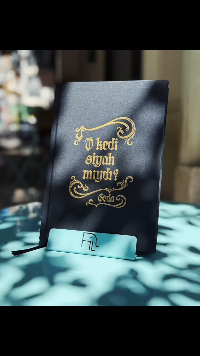 O kedi siyah mıydı? | Was That Cat Black? by @sedagazioglu now available in FiLBooks 🐈⬛
The book is a captivating journey into the world of superstitions, where artist Seda Gazioglu blends years of research, artistic practice, and imagination. This book doesn’t merely explore the superstitions of the past—it questions the ones we live with today and even anticipates those we may one day create. Interweaving cultural rituals, human psychology, and our faith in the unseen, it invites readers to reflect on the comforting illusions we construct to make sense of uncertainty.
Alongside Gazioğlu’s richly textured insights, the book includes intimate pages from her sketchbooks and notebooks, offering a glimpse into the creative process behind the exhibition. Four original essays provide distinct perspectives on superstition:
– Levent Erden, a marketing visionary and cultural commentator,
– Şükrü Necati Şahin, one of Turkey’s most celebrated screenwriters,
– Uzm. Dr. Gizem Güneş, psychiatrist, who subtly analyzes both the artist and the subject of superstition through her evocative storytelling, – and Arda Ekşigil, who captured and preserved a day in the studio, offering a rare look into the making of the work from the inside.
The book was thoughtfully designed by Sibel Simge Karaçalı, whose visual language elegantly carries the spirit of the project across each page.