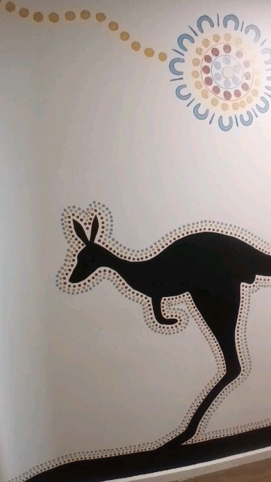 The interior senior level Outback mural I was commissioned to paint at Active Kids Mount Gravatt. The Outback mural features a man playing the didgeridoo, the music he plays carries further and louder through the valley. The dancers are doing the snake dance, calling upon the carpet python.