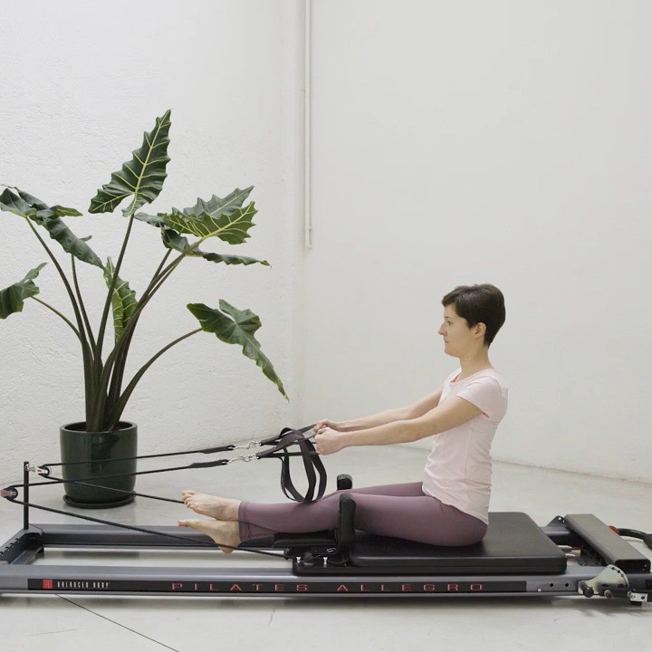 The reformer is a powerful piece of equipment, invented by Joseph Pilates.
This exercise conditions all back muscles and moves the spine from top to bottom. It feels great, especially if you sit down a lot.
The starting position is very important: in the video you can see that the lower back is straight. If you find this challenging, bend the knees and place the feet flat on the headrest.
Grab the straps and roll back, slowly, bone by bone, to a point where you can control the movement; keep the collarbone wide and the shoulders down. To add a variation, grab both straps with the right hand and as you roll back rotate to the left, reaching the left arm behind you.
In the last exercise, we add an extension of the spine: shine the breastbone forward and look up to the ceiling. You will feel the shoulder blades come closer together and glide down the back in a 'V' shape. This is a movement many find difficult, but it is essential to re-balance the time we spend looking down at screens and keyboards.
If you do not have a reformer you can try the moves without any equipment, although it will be more challenging! For extra support, you can wrap a resistance band around a table leg and grab the extremities of the band as you would the straps.
You can also come to our studio and try it out on our reformer.
Let us know in the comments which variation you tried and which one you liked most!
Video credits @moonwalk.studio