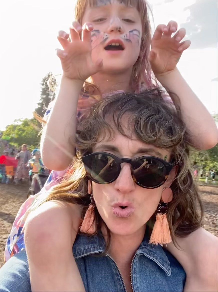 Summer 2023 summed up in a photo. Singing, dancing, face paints, you, me, it’s rained so my fringe has given up, love, fresh air, sillyness. Love. Love and love.
6 weeks has gone too fast. An old lady approached me and instead of saying what they might usually say “enjoy every minute it goes too fast” she flippantly and some what aggressively Said; “I bet you can’t wait for school to start again…” my reply was, I actually love spending time with my daughter. (Cue a big beaming smile to me from roux and a big huff from old lady)
Sure I’ve found it tough to balance work, my life and roux. And things have slipped; exercise, routine, silence. But I’m also lucky enough to work for myself and to be able to carve out the summer for me and her. To take a massive hit income wise and cut classes and work down to the bare minimum, and I’m beyond lucky that I can somehow scrape by over summer, working late at night when she’s asleep.
But to me these summers are non-negotiable, and whilst I can make those work for us, I will. Because these are the hardest, longest, toughest but best days of our lives together.
I’m back to work on Monday! And thanks to everyone who has put classes on pause, people I owe a class too and all my mums who are so supportive to me and my family over summer! A lovely mum messaged me back and said “good for you” when I said I was taking an extra week off once schools are back. (Cue slightly teary eyes)
I see you, and you are my village. See you soon, I can’t wait to be reunited with you all on the mat!! 💖💖💖