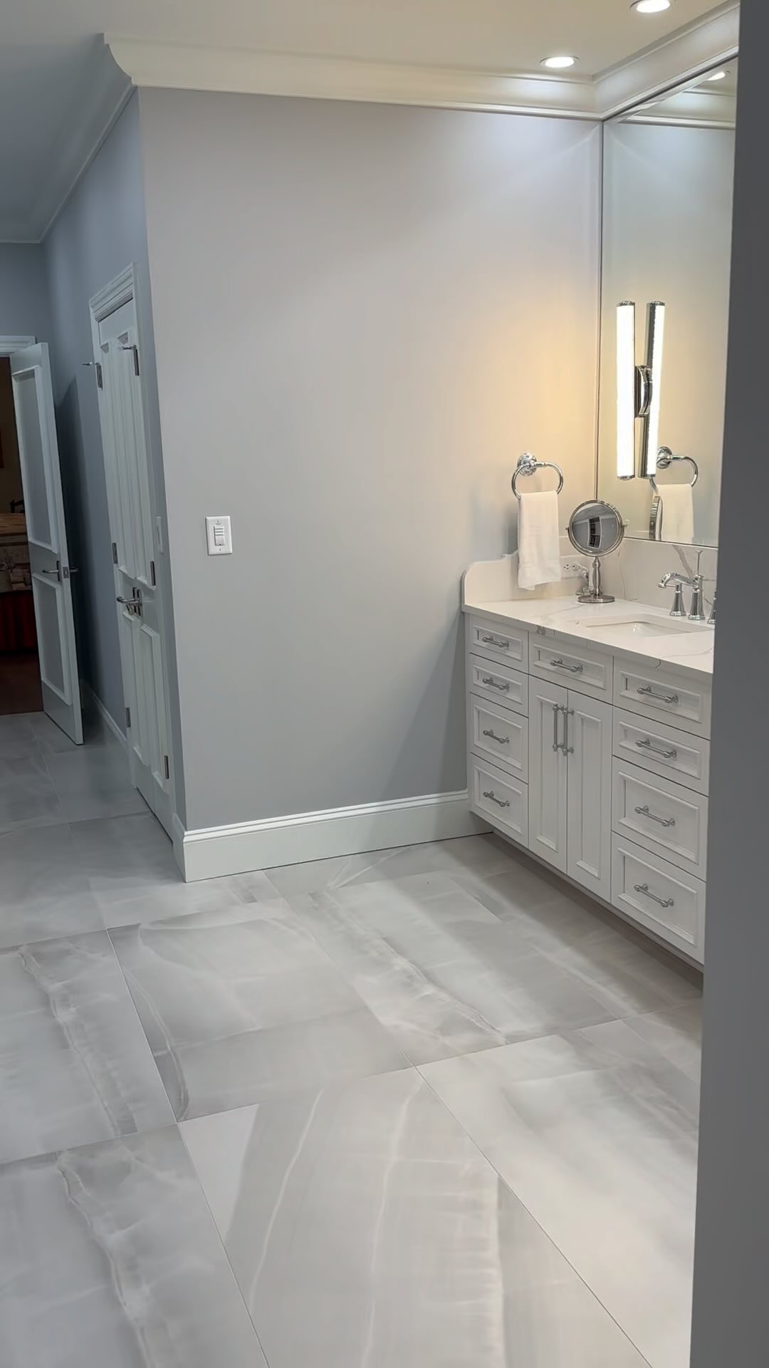 Elegant and sophisticated never has an expiration date! #primarybathroom #elegance #residentialdesign #primarybathroomgoals #renovations #remodeling #truebeauty #urbanbuildinggroup #ubgcharlotte #bathroomremodel #bathroomrenovation #bathroomsofinstagram #bathroomvanity #lightfixture #luxurybathroom @harkeytileandstone