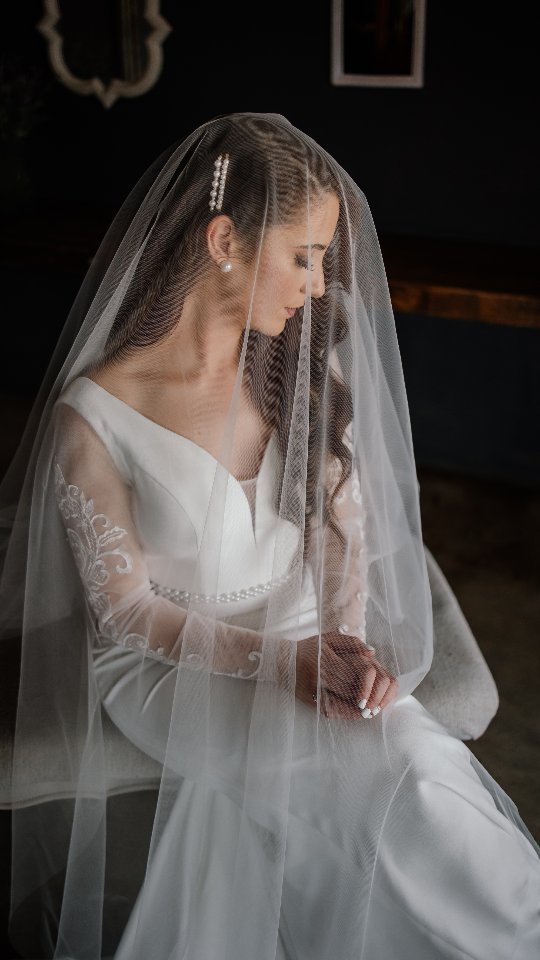 Drawing you into the soft and elegant moments of a bride just before she gets married.
Tips to keep your bridal portrait session calm and enjoyable.
1. The Biggest tip: Do not do your makeup and hair last. Be first because if anything runs late, you will be done and your bridesmaids can finish up while you start with your portrait session.
2. Schedule out enough time for your portrait session.
3. Make sure you have fitted your dress before the day and that the person that needs to help you get in your dress has practiced before to get you in.
4. If you are using any type of tape on your chest, practice beforehand. Make sure you know on the day how to make everything look elegant and perfect. This can lead to a lot of unnecessary stress on the day.
5. Lastly, allow your photographer to guide you. We are your best cheerleaders, your moral support and we want you to enjoy the day.