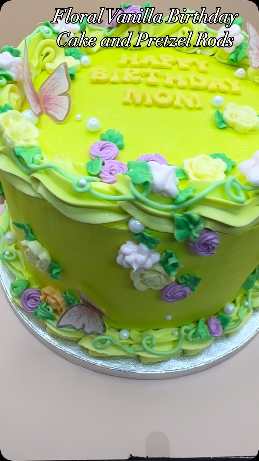 Celebrating Mom with a Floral Vanilla Birthday Cake and Pretzel Rods. Elevate your celebration with a cake and custom treats ensemble! Contact Baked XPressions for your customized creation. #MothersDay