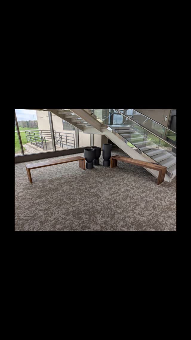 Simple clean waterfall walnut benches for a corporate lobby.