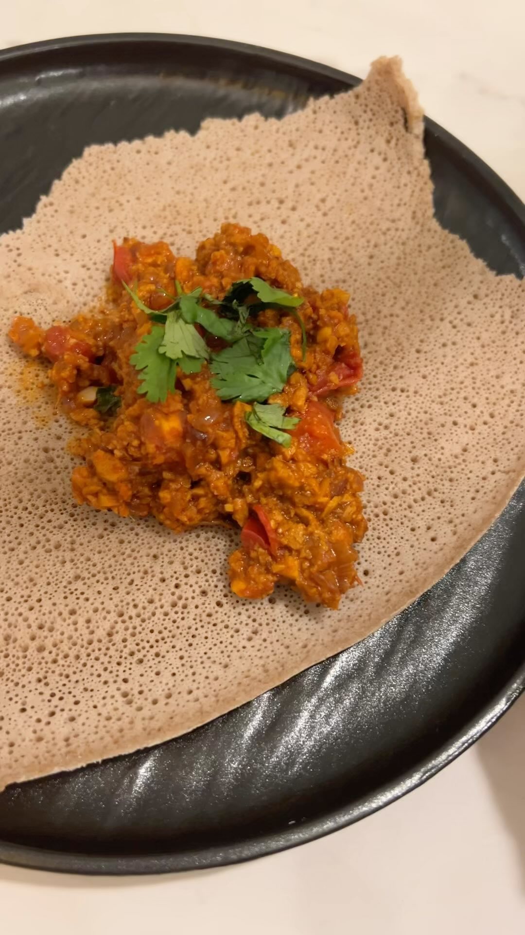 Snag the recipe below!
Recipe:
-1, 10oz bag, MorningStar Farms meal starter crumbles
-2 tomatoes, diced
-1/2 medium red onion, diced
-2 Tbsp tomato paste
-2 Tbsp Berbere spice
-2 Tbsp minced garlic, about 6 cloves
-2 Tbsp fresh grated ginger
-2 Tbsp water
-1 Tbsp Niter Kibbeh (Ethiopian spiced clarified butter)
-1/2 tsp salt
Preheat multi-cooker appliance using sauté feature.
Sauté onion in Niter Kibbeh until onions are soft and browned.
Add garlic, ginger, Berbere, and salt. Saute until garlic is fragrant.
Add in crumbles and stir.
Add tomato paste, tomatoes and water then cover and switch to soup mode to simmer for for 7-10 minutes.
Serve with fresh injera.
Enjoy!
#MSFRecipeContestEntry #plantbased #EritreanFood #EthiopianFood #flavor #danielletherdn #diversifydietetics