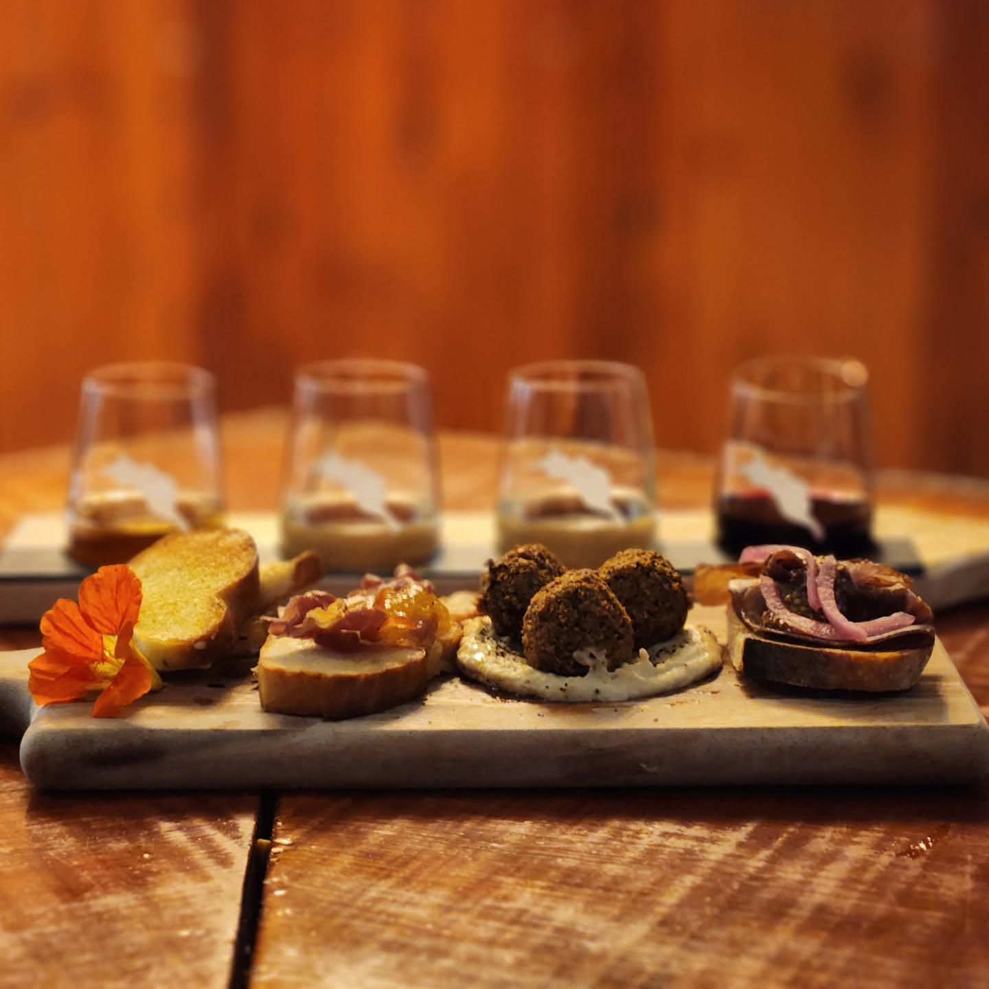 Introducing our new Vineyard x Garden Board — a curated tasting experience designed to highlight the perfect harmony of wine and food.
Enjoy 4 thoughtfully paired bites with 4 pre-selected wines for $40 per person. Available both at the winery and in the restaurant.
Sparkling Strawberry Vidal + Focaccia grilled cheese, brie, honey & nasturtium
Pinot Gris 2024 + Focaccia with peach bonnet jelly & charred prosciutto
Gewürztraminer 2024 + Wild leek falafel, hummus & sumac
Cabernet Franc 2024 + Red fife tartine with beef bresaola & pickled onion
Each pairing is meant to shine together — no swaps, just a deliciously intentional tasting journey.
Come sip, snack & savour the season with us in the garden or dining room.