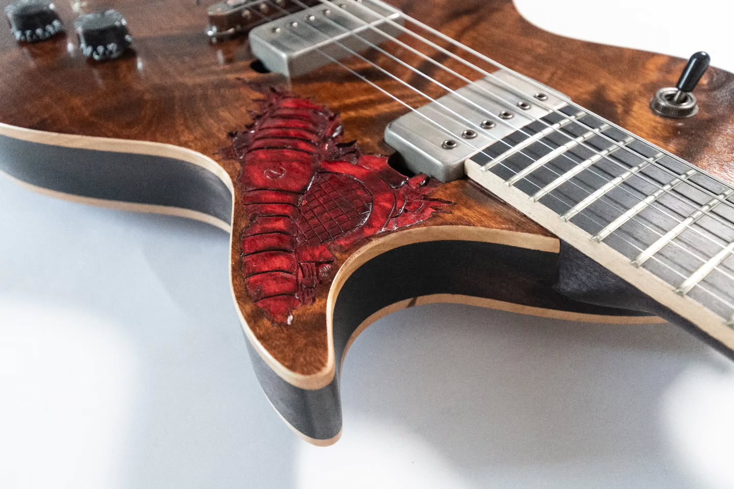 A detail shot of the 10th Anniversary carves. Should do more of this kind of chip-carving on my guitars?
This technique is what got me into woodworking. My grandfather taught me to do some chip carving and gifted me a set of chisels and knives. When I years later found them again, I carved up the top of a cheap guitar and that experience pretty much changed the course of my life.
I went to study woodworking and cabinetry, with guitars worked on in the background throughout my studies. To commemorate that guitar, I built this 100% hand made version in 2022.
And IT IS STILL AVAILABLEš