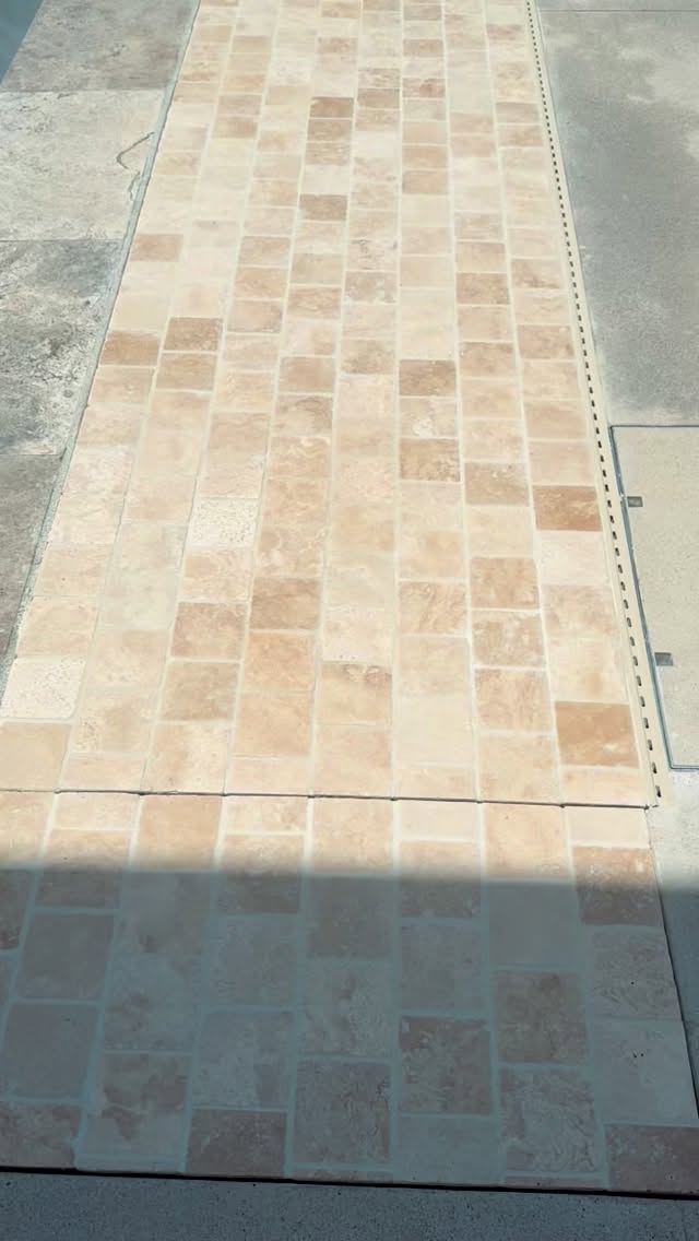 Bringing beauty to this Mission Viejo backyard with a warm, soft cobblestone deck, custom installed white concrete and seamless pool covers for a clean, polished look. #poolremodel #orangecountyhomes #modernpooldesign #outdoorliving #homeimprovement #cobblestonedeck #whiteconcrete #exteriordesign #luxuryhomes #transformation #backyardgoals