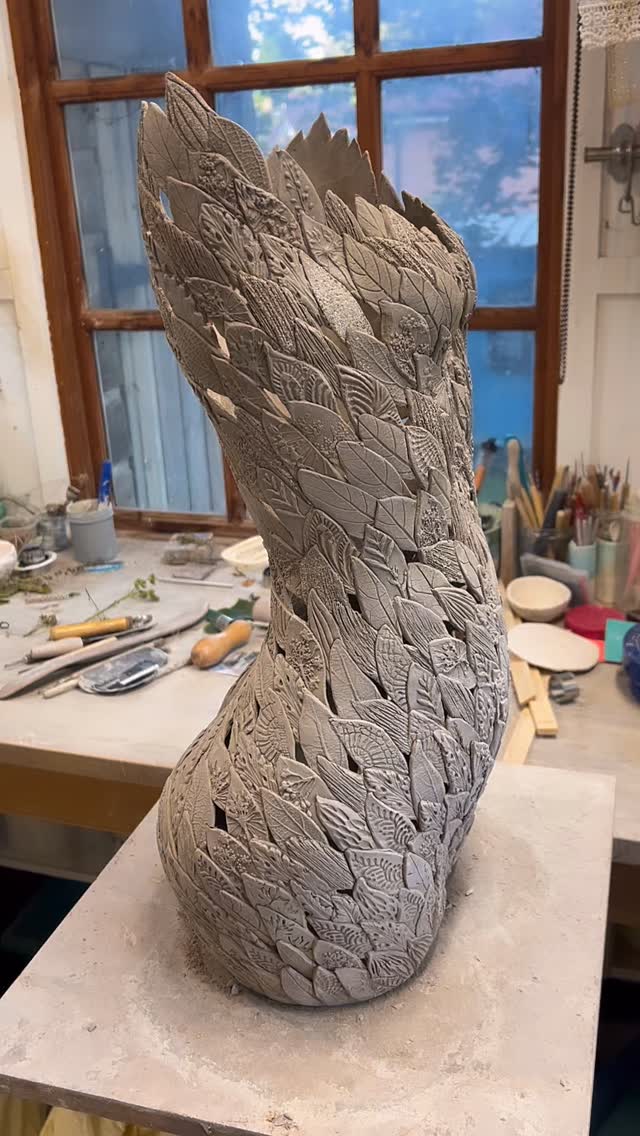 I’m so happy that this sculpture l’ve been working on has dived into the kiln for her first firing.
This sculpture has taken me two weeks to build, nothing else being made alongside her, just full concentration of making her well. She’s built leaf by leaf, one by one,
“freehand”. Each leaf has its own impression added and then is added on. It’s a slow methoditive process but one I so enjoy. I’ve been lost in it completely and loving every minute of it. Seeing the piece grow gently is so exciting.
I don’t always feel I’m doing the work, strangely I feel like it’s a journey I take and just hope each day she will move forwards with me. Thankfully she has so far.
It will be a few more weeks until she is complete. She will need glazing, firing and then I will do some gold lustre detail on her.#clay #sculpture #ceramicart #ceramics #pottery #maker #smallbusinessowner