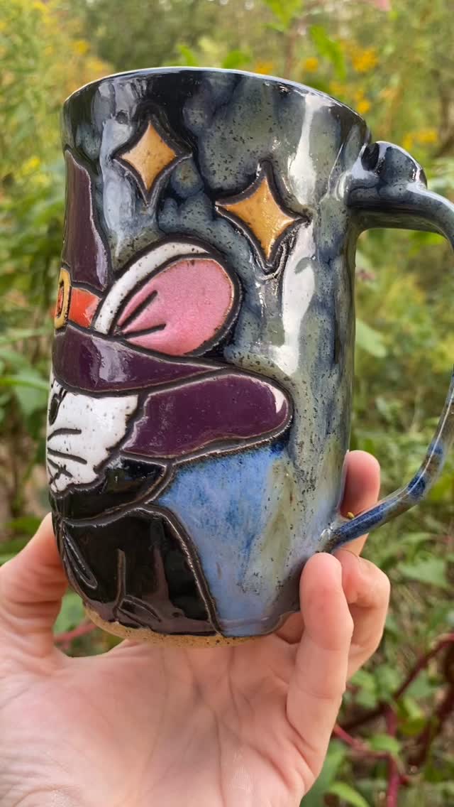 I just love this mug and it makes me feel super proud of my work - it’s lightweight and feels good in my hand, the artwork (I just love animals in human clothing, especially a witch hat 😍) and then I felt like my glaze choices were a bit risky but when they work out it’s totally worth it! I love how the black and blue glazes work together with the crystal glaze on top. I’m still glazing another mouse witch mug and decided to make the mouse gray so hopefully it turns out as cute 🤞🏻 🧙 🐭 🖤🧡 #handmadepottery #appalachianart #mugcollection #madeinwv #handmademugs #appalachianartist #stonewaremugs #halloweenmug #halloweenmugs #witchmug #mousewitch