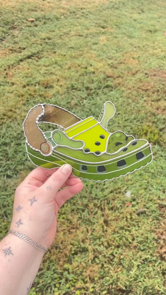 All the Shrek pieces we made for Shrektoberfest at @dssolvr_durham this past weekend! What an amazing crowd, and the weather ended up being great! These were so fun to make - @glass.creature absolutely crushed all the painted details as usual. The VHS tape actually uses some uranium glass from @fremont_antique_glass ! And it is still available for the Shrek lover in your life 💚🧅📼 major shoutout to @thepufferfishproject who organized this event!!