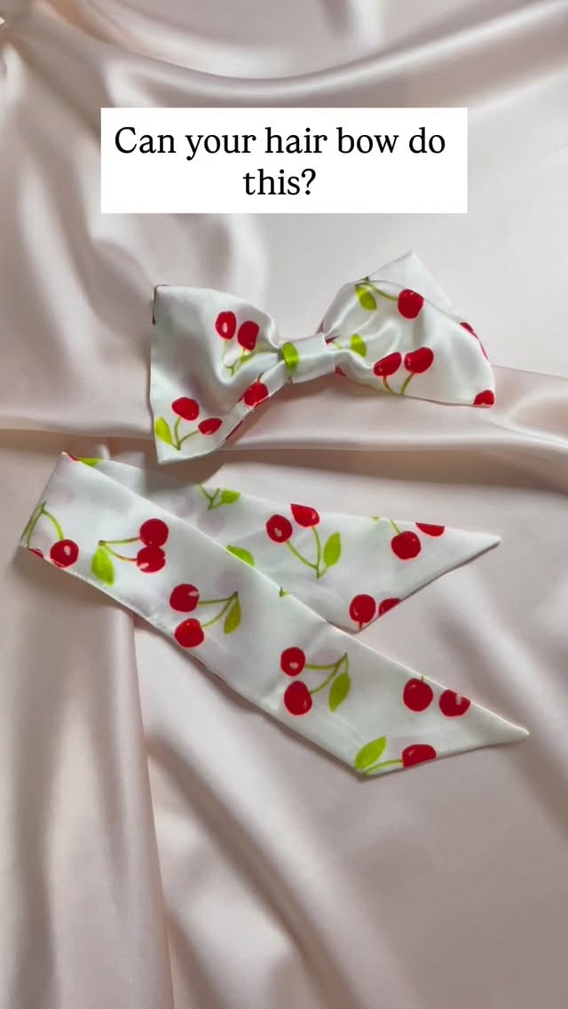 Get yourself a hair bow that can do both! The Euphrasie silk hair bow has detachable tails so you can choose from two hair bow styles in one.
Video description- a silk hair bow in white with a cherry print and matching mini ribbon. A hand grabs both and when the bow is dropped back down the tails have been added into the hair bow to make another bow style