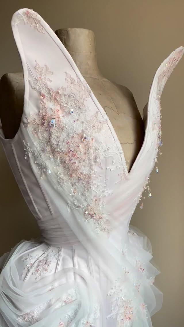 • Seraphina •
An ode to light and movement.
Soft layers of tulle where carefully draped across the form, adorned with delicate lace in shades of pale pink and ivory to add rich texture, and finished off with crystal droplets that glimmer gently in the light.
Handcrafted with patience and precision, this piece is both a soft embrace and a commanding silhouette. Where timeless craftsmanship meets whimsical elegance.
#EmiahCouture #Emiah_Seraphina
