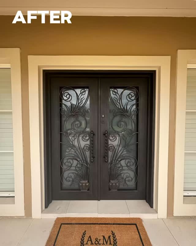 Timeless elegance. Custom design iron door featuring operable glass panels, hand-brushed gold accents, and H500 extra-long handles.