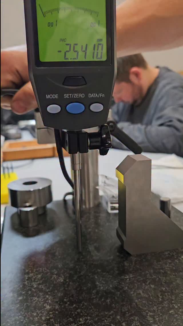 One of our new hires, Jack, had the task to make a setting aid for our longer throw indicators we use.
The granite stand we have is a bit strange in the fact that the tilt of the indicator is adjustable, I'm sure there are scenarios where thats useful, however here, on a longer travel indicator, this can cause some fairly annoying errors over the measurement length.
Jack started off with an offcuts of hardened A2, did the surface grinding, wire cutting and lapping, and final measurements of the jig himself. Not bad for the week 2 on the job!
Proof is in the pudding, the indicator is reading zero across a 40mm measuring length straight out the gate after being set with the jig.
Toolmaking is the foundation of precision manufacturing.