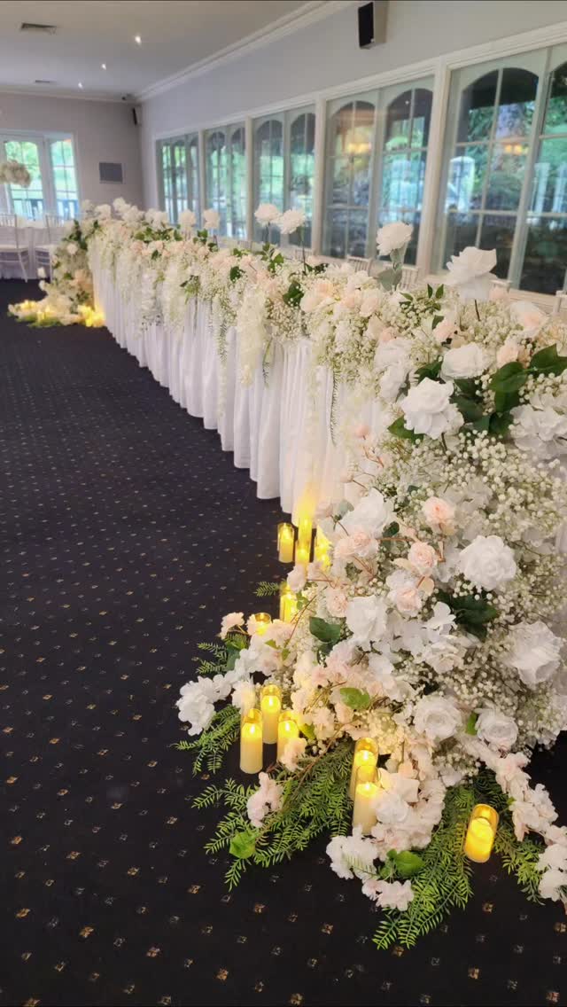When Ellie and Jack envisioned their reception, they wanted romance, scale, and softness all in one moment.
A 7 metre bridal table framed with cascading floral waterfalls, paired with guest table florals to carry the look throughout the room.
Our full romantic baby’s breath range was elevated with delicate peach roses and soft greenery, creating movement, depth, and an unmistakably timeless feel.
Designed to feel abundant, and completely in harmony with their celebration at the beautiful Nathania Springs.
Venue: @nathaniasprings
Bride: @ellcarey_ kra_
Groom: @jackcareey @jackcareyy_
Videographer: @kimberleymooremedia
Celebrant: @marriedbygeorgia
Photography: @countrymilephotographyaus
Hair: @harymay_bridal
Makeup: @melissadmakeup
Dress: @littleparis.couture
Flowers, props, styling, Candles, concept: @decodays - Faux Flower Studio
White dancefloor (non-negotiable IMHO 😆) @melbourne_wedding_designers
#weddingreceptiondecor #bridaltable #melbourneweddings #weddingstylistmelbourne #nathaniasprings