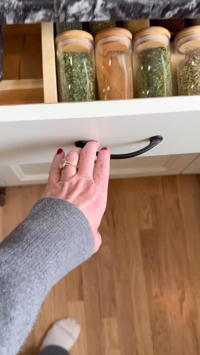 TSS refreshed this space by giving spices, oils and tea essentials a better home with a pull-out spice drawer, a blend of existing and new organizers, labels and remote-controlled LED lighting to complete the look! #kitchenorganization #homeorganization #pantryorganization #drawerorganization #kitchenhacks