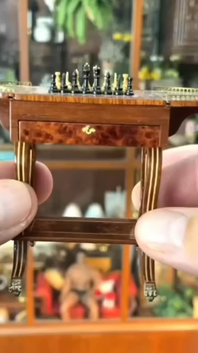 This Antique late 19th century 1:12 scale lyre base hardwood gaming table is by Geoff Wannacott and features inlay table top chessboard with opening felt lined drawer with real dove detailing holding accessories, brass accents along the fold down table top with metal claw feet ending at carved and curved table legs. This piece is from a previous estate sale I hosted. If you’re looking to downsize your collection of dollhouse miniatures, reach out and let’s talk about how we can work together to find new homes for your adore treasures. #Dollhouse #Antique #FineArtMiniature.