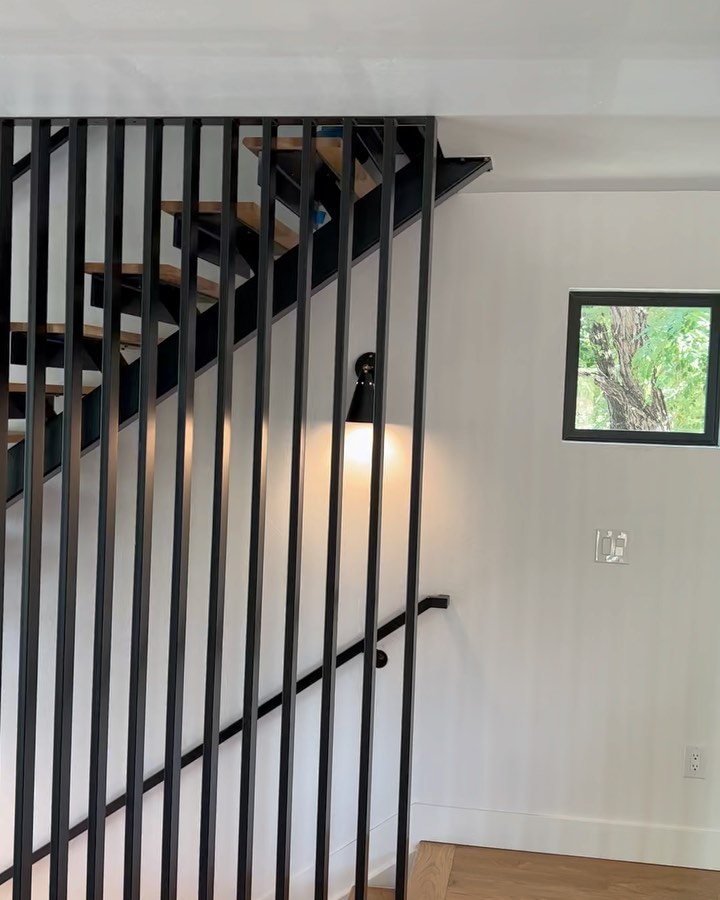 Mono stringer stairs with guard rail going from floor to ceiling.