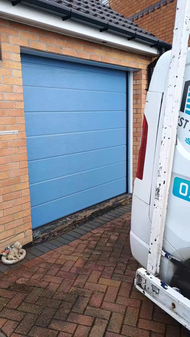 What a refreshing change.
Fully insulated sectional door, electric with remote control and colour matched frame.
If you don't want white, grey or black just take a look we can offer virtually any colour.
This is a nice looking pale blue to match the front door.
If you are interested in this please get in touch we would love to hear from you.