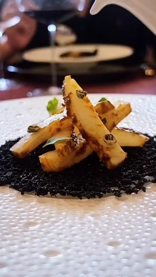 It was literally “nessun dorma” where the sea met land at Italy’s busiest port city of Napoli when they first created “puttanesca”.
Bustling 24 hours a day, it was in the dead of night that day’s catch made shore. Weary fishermen waiting for night and stars to be banished; for the first fruits of their labour to be transformed into a soul-warming bowl of goodness better than … well, you know what … Ahh puttanesca!
Our puttanesca brodo starts with a collagen fish broth, to which we add the puttanesca components and simmer to give a touch of spice, a punch of umami, and a refreshing twist of citrus to brighten the intensity of crushed garlic, capers, and olives.
This is then poured over flame-licked confit squid accented with basil, lemon zest and dried capers atop a crispy squid ink tuile.
The fisherman’s triumph. The glory of the seas. Enough for them to call out, and perhaps us with them: “vincero!”