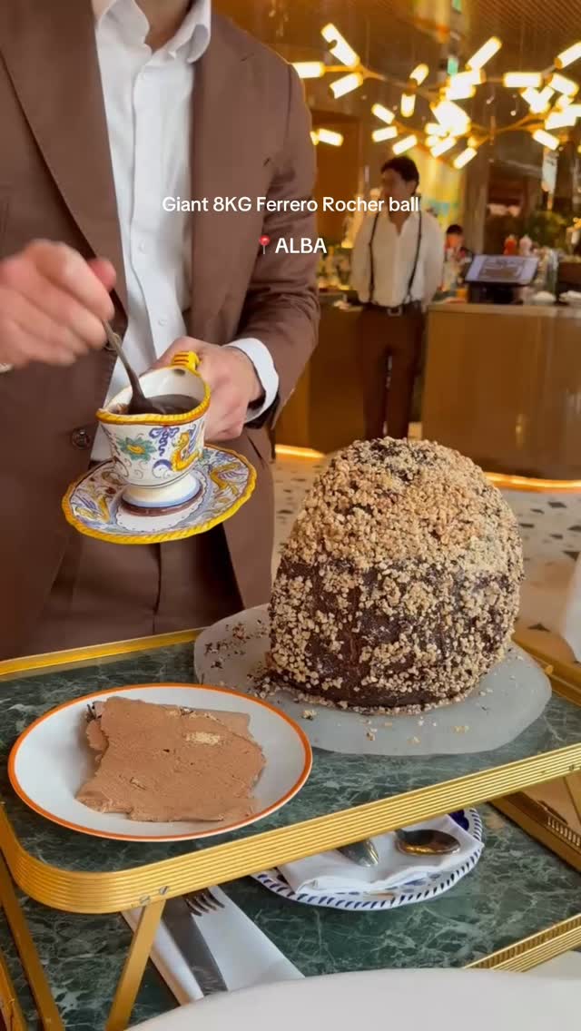 ALBA London giant Ferrero Rocher ball is one of those desserts that you want to take a bite out of just for the looks of it. This beautiful creation is cut at your table, and the inside is ice-cream mixed with the well-known Ferrero Rocher chocolate balls. It has chocolate sauce and hazelnuts on top. What excites us is they also have the Raffaello ball option with white chocolate and almonds on top. It is definitely one of those experiences to try out. Price is £22, you get a good slice out of the huge thing!
#albalondon #ferrerorocher #desserttiktok #giantfood #fyplondon