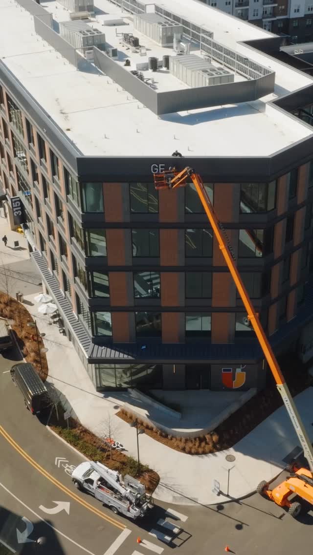 OFFICE NEWS: Our first tenant, @genesyscx, has installed its signage and officially moved its regional office into Horseshoe! 🏢 Built by @choateconstruction and designed by @iaarchitects with furnishings from PMC and Raleigh Reclaimed, the company’s fifth floor space celebrates many working styles, including enclosed offices and open desks, focus and team rooms, collaborative areas and conference rooms, a video production suite, cafe and multiple lounge spaces, and a portion of the fifth floor terrace. Horseshoe’s LEED v4 certification and environmental design played a meaningful role in the company’s decision to relocate, and Genesys plans to submit its space for LEED Interiors certification. ♻️
Please give the Genesys team members a warm welcome if you see them around Horseshoe. We are so excited to have them here!
🎥: @pressrecordmedia