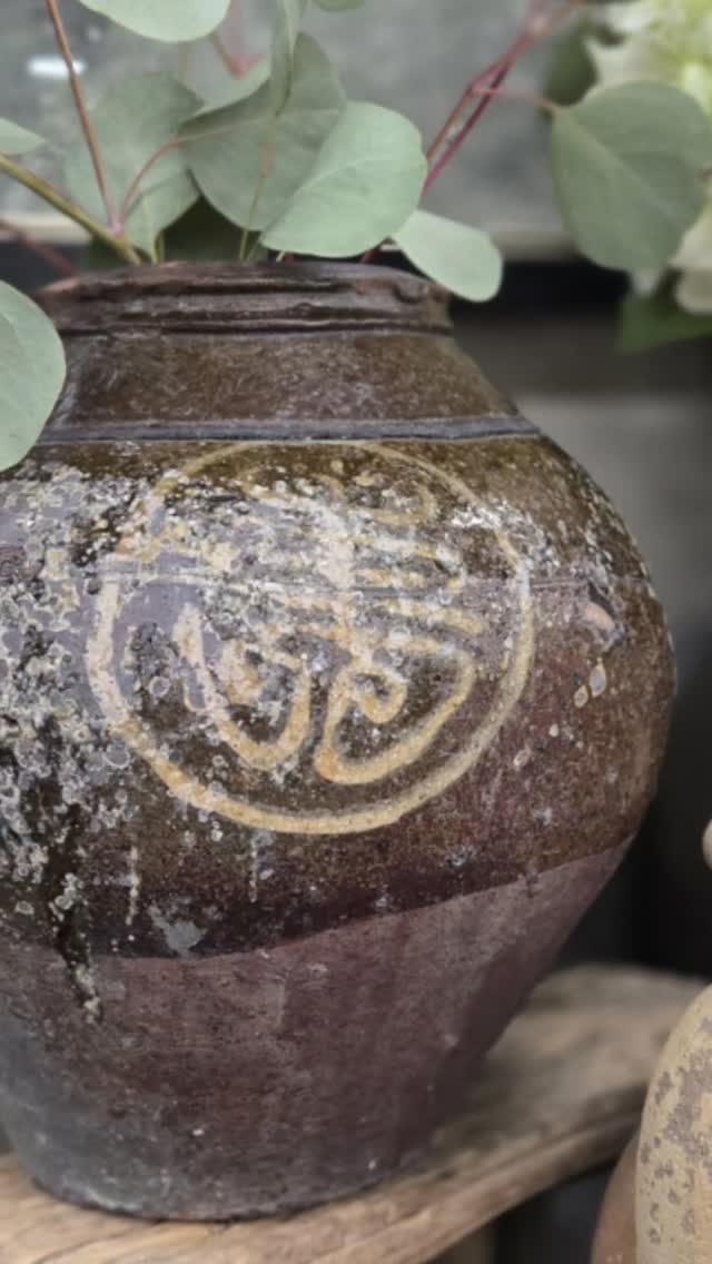 One of our favorite finds lately! This beautiful vintage Chinese stoneware storage jar features a hand-painted character medallion and rich brown iron glaze with decades of natural patina. Pieces like this were traditionally used for storing rice wine, soy, or fermented goods — but today they make the perfect statement piece for rustic, antique, and collected home decor.
We love styling these antique pottery jars with simple greenery or dried stems to highlight their texture and history.
Come see it in person this weekend at @vintagemarketdayslittlerock — we’re set up at the Arkansas State Fairgrounds through Sunday. So many beautiful vintage finds, antiques, and collected home decor waiting to be discovered.
#vintagehomegoods #collectedhome #decorwithhistory #foundandcollected #jc_homegoods