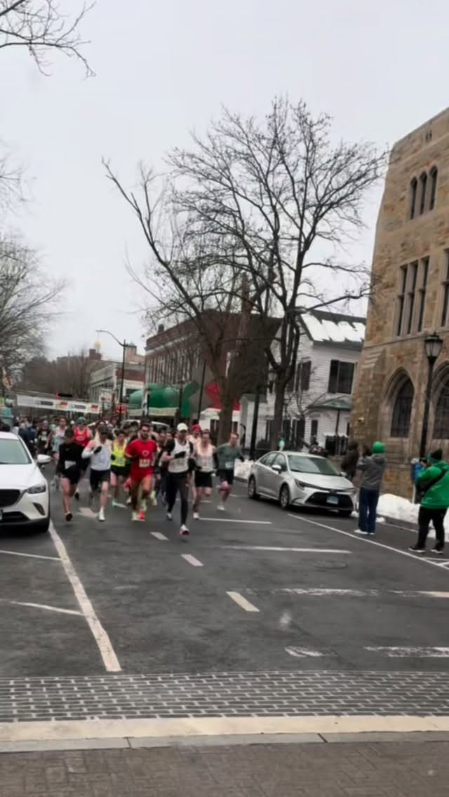 On a freezing, snowy morning that would have scared off most people, our team showed up en masse to defend our home turf at the Shamrock N’ Roll 5K, and we did not disappoint. Despite the biting wind, New Haven Road Runners were out in force, bringing the energy, the grit, and some seriously strong racing to kick off the season.
Our open women’s team placed first, the open men’s team third, and both the women’s and men’s masters squads finished 4th! A full-team effort across the board!
Highlights
- Andie Condie, our amazing racing captain, was first woman overall and now sits 7th on the leaderboard (17:23)
- Lee Carlisle (17:11) moved into 2nd on the masters leaderboard, and Aaron King (18:32) landed 5th on the 5K masters leaderboard
- Super Parents: Josie (20:40) and Jake Jayworth (16:06) made insanely strong racing debuts as parents. It was also Brittany Battis’ (19:50) first race as a mom, and Stefanie Gillson (19:32) crushed her first race back after having her second little one (and missing the start). All of them welcomed babies just this past fall!
- PRs: Tiger Lu (16:14), Olivia Provance (18:39), Joon Lee (19:33), Katie Overstrum (18:17), Bryan Bausinger (16:46), Ellianna Boothe (21:03), Tristan Lawrence (20:47), Steven Urgiles (20:38)
- Age group awards: Katie Overstrum, Olivia Provance, Mary Johnson (19:22), Kathryn Miller-Jensen (21:43), Jake Jayworth, and Lee Carlisle
- Shoutout to new racing team members: Ala Oueslati (18:03), Zachary Abeles (22:49), Katelynn Romanchick (20:10), Francois Stockart (18:25), Jose Perez (18:35), and Daniel Purschke (21:09)
Beyond the times and age placements, it was one of those mornings that reminded us why we race together: tough conditions, loud cheers, frozen fingers, bunches of bananas, and a whole lot of heart. Huge thanks to the race organizers and volunteers for putting on such a smooth race, and to Metered Exposure (@meteredexposure)for the incredible photos. It was a super strong start to our season! Next up on our circuit race is the Cheshire Half Marathon on April 12!
