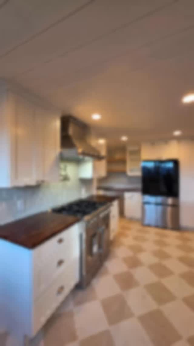 Can you tell that this kitchen has reused cabinets?
We changed the layout of the kitchen by removing cabinets and reinstalling them in a new location. And then adding cabinetry to create an island and new workspace for better functionality. But functionality wasn't the only thing on their mind with reworking their kitchen layout. The stunning checkerboard pattern tile floor and custom built butcher block counters are definitely show stoppers as well! 203-778-9385