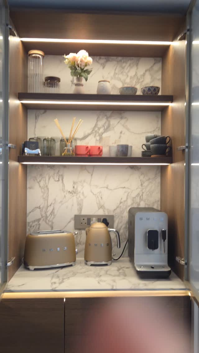 A hidden coffee & tea station designed with elegance and functionality in mind.
Featuring illuminated shelves, a luxurious stone splashback, and fine reeded glass doors for a refined, modern finish.
#CoffeeStation #LuxuryInteriors #CustomCabinetry #ModernInteriors #MinimalDesign
