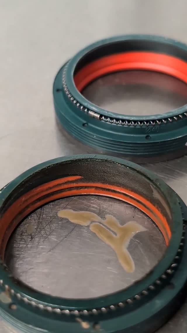 I'm a big fan of the dual compound @skfgroup wiper seals, but they are a product best suited to racing.
In order to reduce the friction, as well as two different compounds, the garter spring isn't as tight. This also means that the seals are more prone to investing dirt and water and as a result, they will need changing more often. This isn't so much of an issue for a race bike as maintenance tends to be more frequent than a park bike.
The used seals are about 5 months old and 4 races deep so they are past their best and as a result the foam rings under them were also looking well used and the oil in both legs also confirms it's time for a refresh. A 3 month life span for these seals is probably about right for typical UK use in order to keep performance where it should be.
#datadrivendescents
#engineeringspeed #suspension