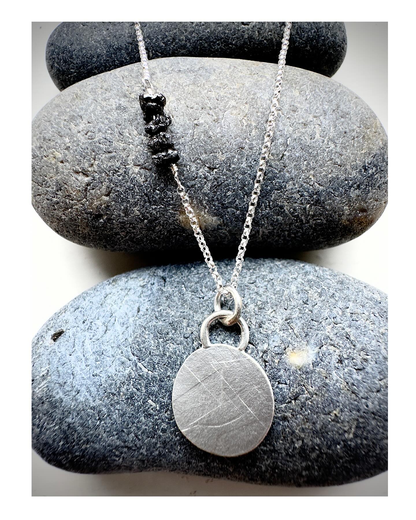Soft brushed silver monoprinted charm on silver chain with stack of raw black diamonds. A beautiful delicate wearable necklace. Come and take a look this weekend at the Holt festive market #artisanstudiojewellery #rawblackdiamonds #preciousprintjewellery #diamondsareforever