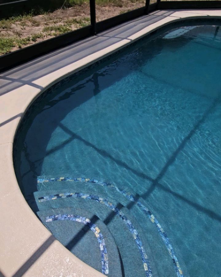 Tropical Blue Pebble & Irridescent Glass tile to compliment this cozy backyard Pool & Spa! Beautiful combination!